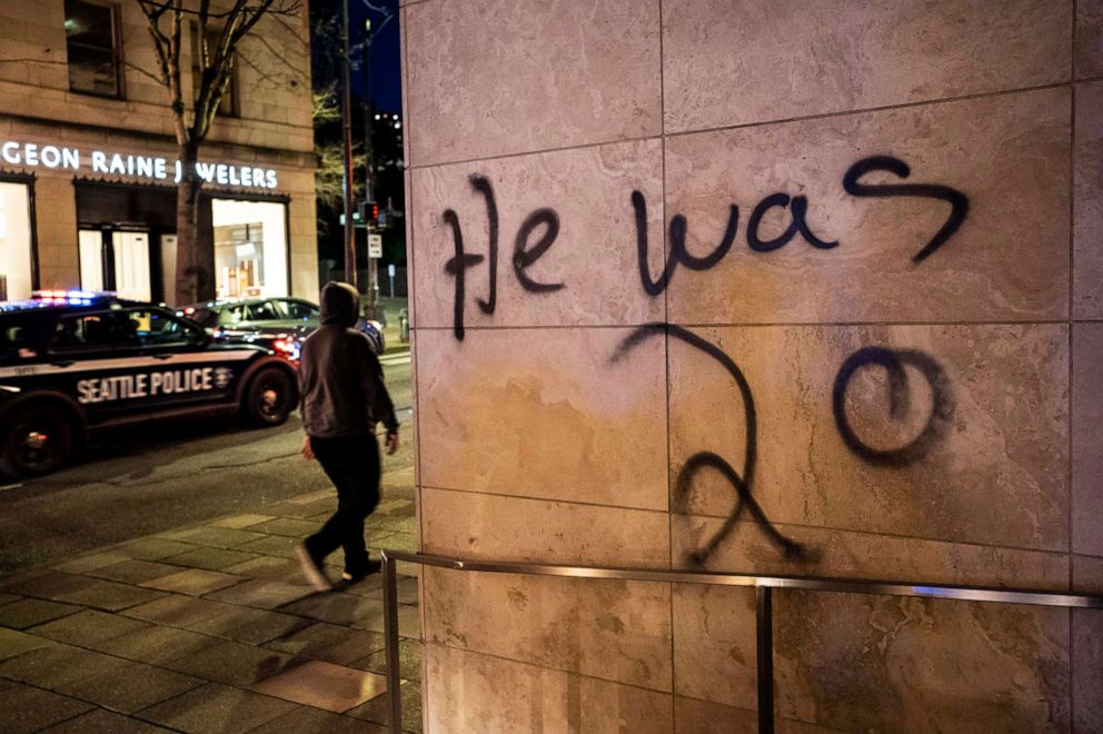 PHOTO: Graffiti sprayed on a building at a protest over the death of Daunte Wright on April 12, 2021, in Seattle.