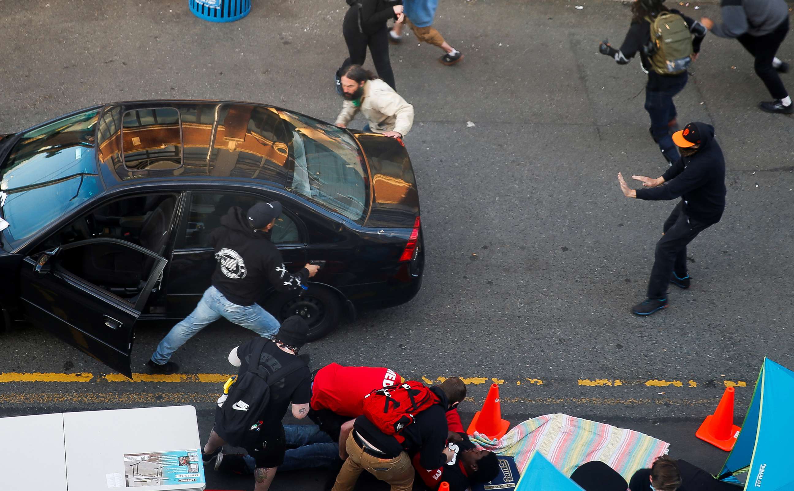 PHOTO: A man exits a vehicle after being shot in the arm by a driver who tried to drive through a protest against racial inequality in the aftermath of the death in Minneapolis police custody of George Floyd, in Seattle, June 7, 2020. 