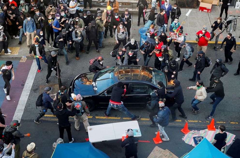 PHOTO: Dan Gregory appears to try and enter the vehicle of a man who tried to drive through the crowd during a protest against racial inequality in the aftermath of the death in Minneapolis police custody of George Floyd, in Seattle, June 7, 2020.
