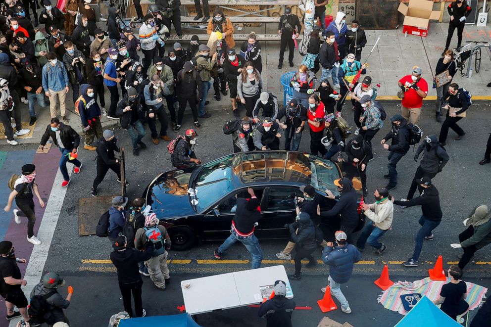 PHOTO: Dan Gregory appears to try and enter the vehicle of a man who tried to drive through the crowd during a protest against racial inequality in the aftermath of the death in Minneapolis police custody of George Floyd, in Seattle, June 7, 2020.