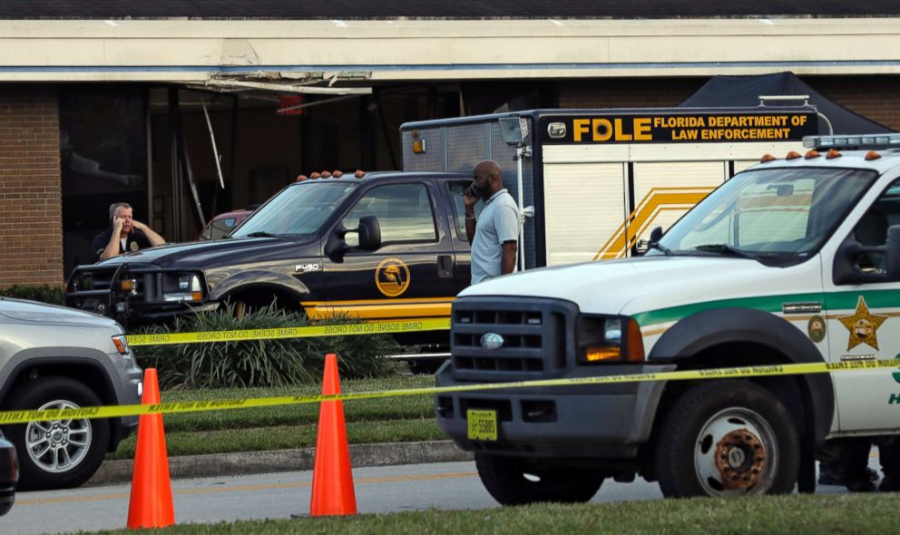 PHOTO: Law enforcement officers stand near a Florida Department of Law Enforcement vehicle that is parked in front of SunTrust Bank branch, Jan. 23, 2019, in Sebring, Fla..