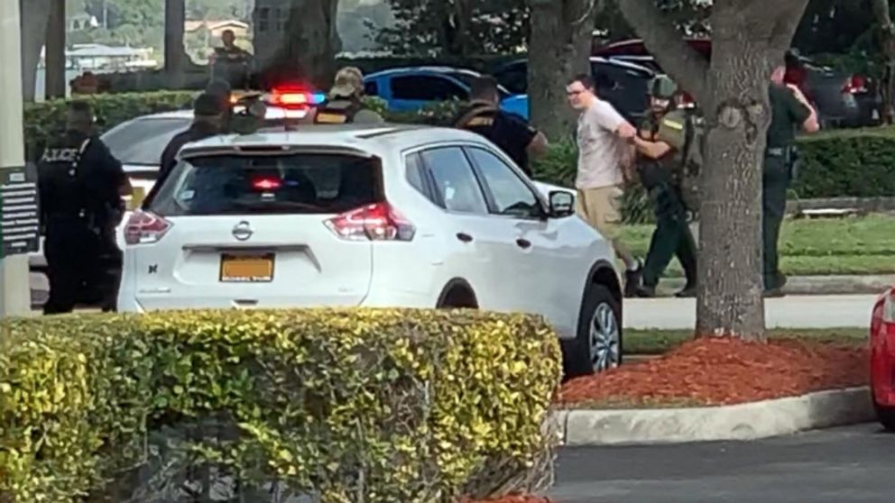 PHOTO: Video shared on social media shows a man being led out of a SunTrust branch in Sebring, Fla., after a shooting on Jan. 23, 2019.