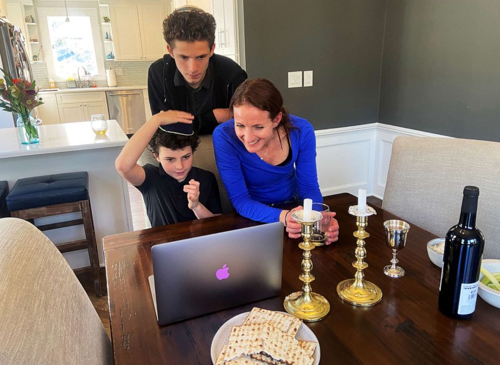 PHOTO: Cheryl Noah and Alex Barkin use a computer during a family Passover Seder to connect with relatives who are unable to gather together due to the outbreak of Coronavirus disease (COVID-19) in Maplewood, N.J., April 8, 2020.