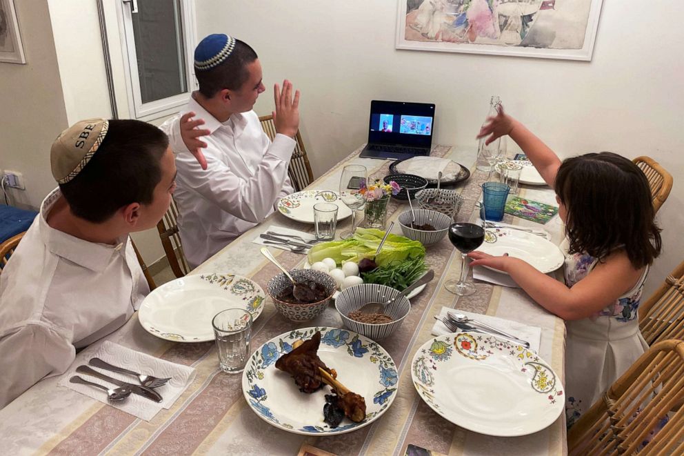 PHOTO: Three siblings in Mevasseret Zion, near Jerusalem, wave to their their grandmother in Haifa as she joins their Passover Seder via Zoom video conference as Israel takes stringent steps to contain the coronavirus (COVID-19) April 8, 2020.