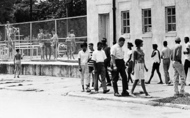 PHOTO: People march in protest of the all-white policy at a segregated swimming pool in Cairo, Ill., July 23, 1962.