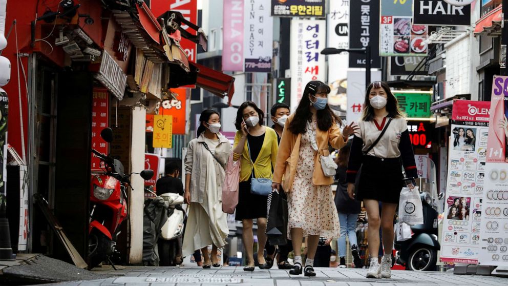 PHOTO: People wearing masks walk at Myeongdong shopping district amid social distancing measures to avoid the spread of the coronavirus disease (COVID-19), in Seoul, South Korea, May 28, 2020.