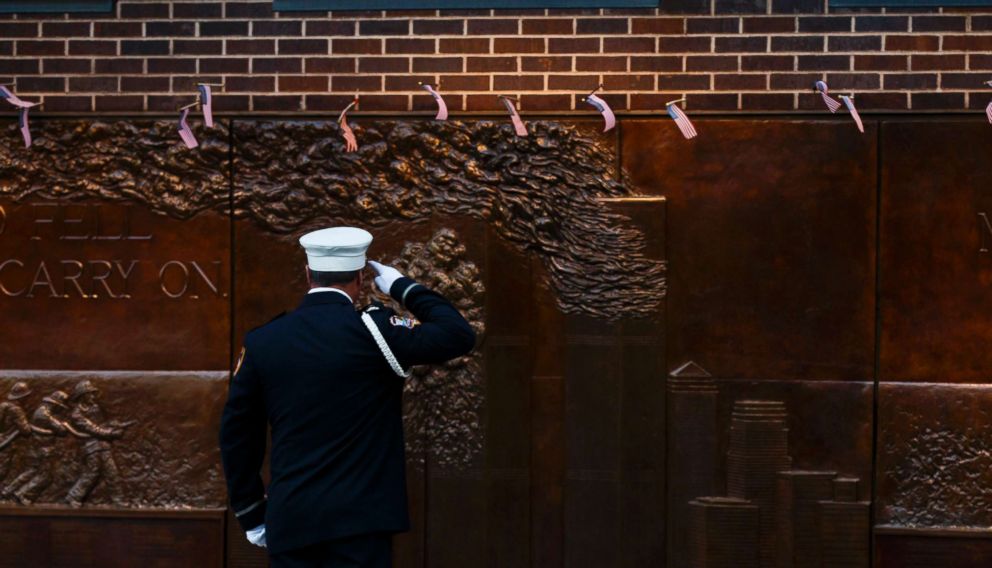 PHOTO: A New York firefighter salutes at a 9/11 memorial wall, erected for the 343 firefighters who were killed that day, on the 16th anniversary of the September 11th terrorist attacks in New York, Sept. 11, 2017.  