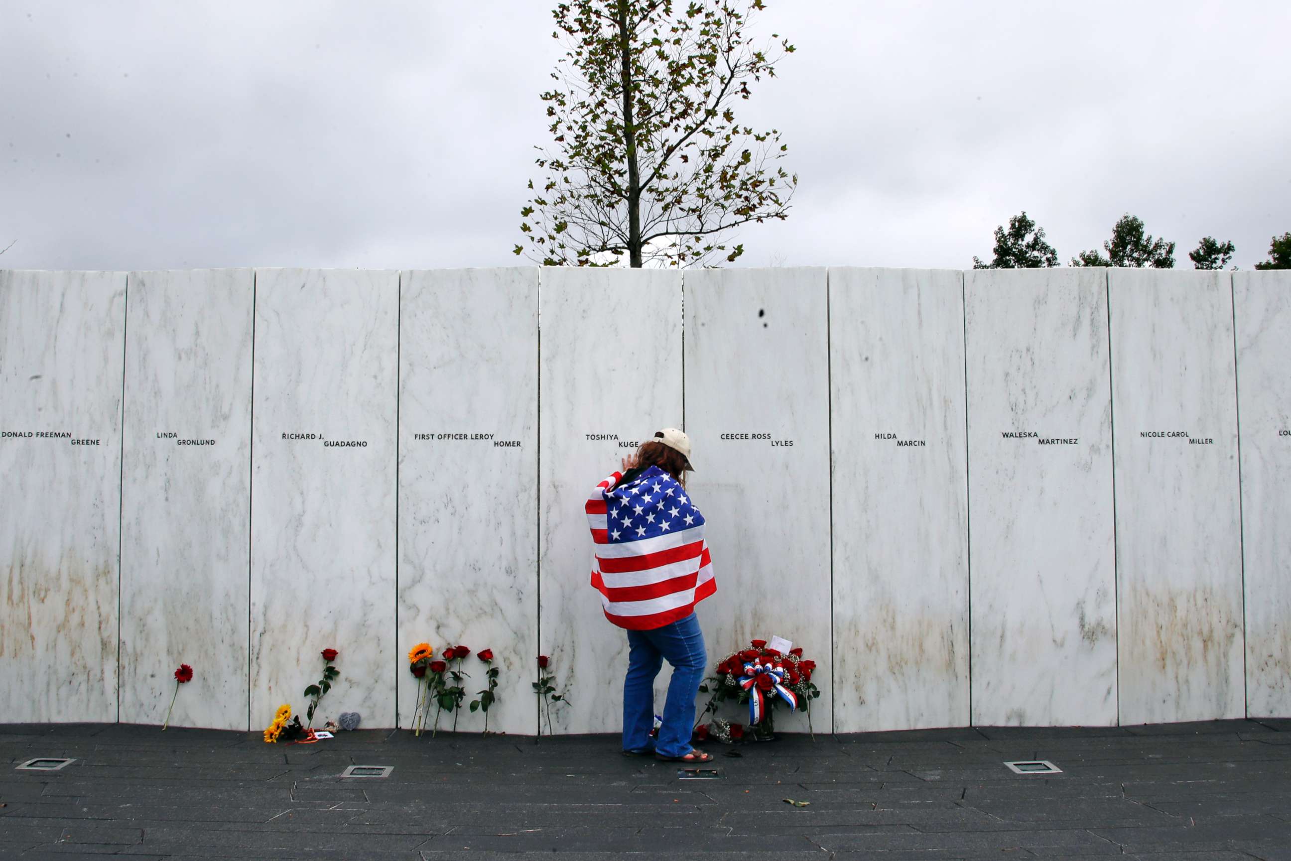 PHOTO: Chrissy Bortz of Latrobe, Pa., pays her respects at the Wall of Names at the Flight 93 National Memorial in Shanksville, Pa. after a Service of Remembrance, Sept. 11, 2018, as the nation marks the 17th anniversary of the Sept. 11, 2001 attacks.
