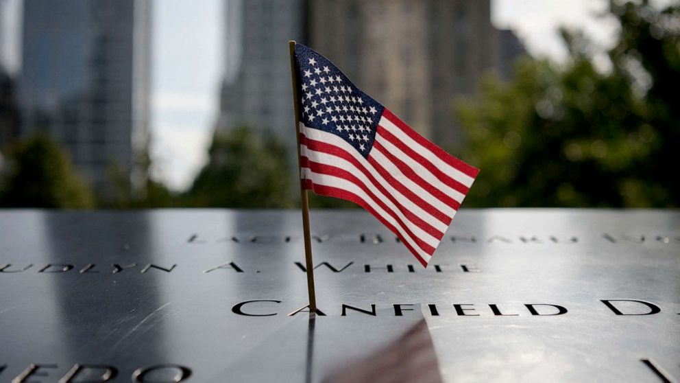 PHOTO: A US Flag adorns a name at the National September 11 Memorial site of the north tower at World Trade Center in New York, Sept. 8, 2021.