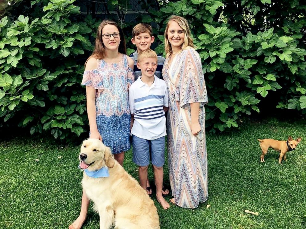 PHOTO: Hannah Westmoreland (left) is pictured with two of her siblings and her service dog Journey.