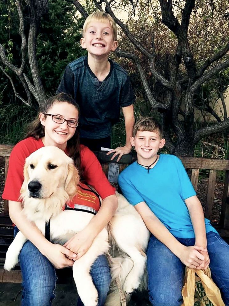 PHOTO: Hannah Westmoreland (left) is pictured with her siblings and her service dog Journey.