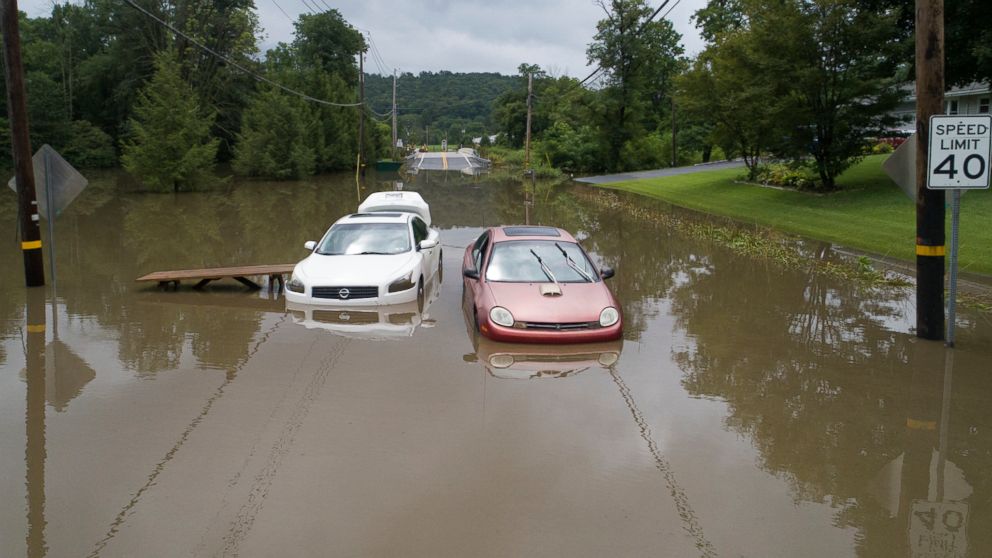 PHOTO: Abandoned vehicles and picnic tables sit along Route 645 in Pine Grove, Pa., after flood waters from a storm stalled them, July 23, 2018.