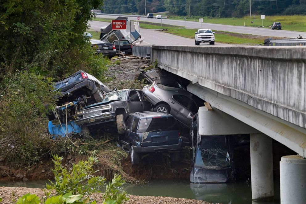 PHOTO: Cars are stacked on top of each other on the banks of Blue Creek being swept up in flood water, Aug. 23, 2021, in Waverly, Tenn.