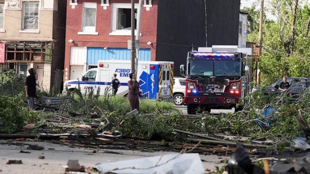 People survey damage after a severe storm moved through Friday, May 16, 2025, in St. Louis. 