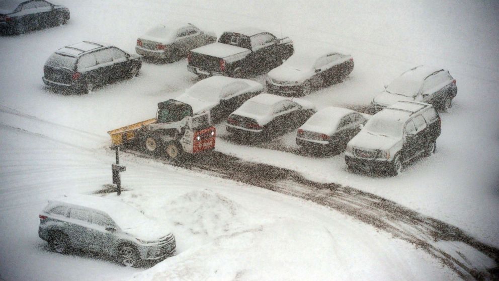 PHOTO: A snowplow makes its way past snow-covered cars in a parking lot in St. Paul, Minn., March 5, 2018. 