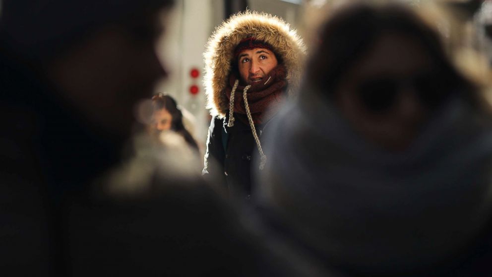 PHOTO: People walk through a frigid Manhattan, Dec. 28, 2017, in New York City. 