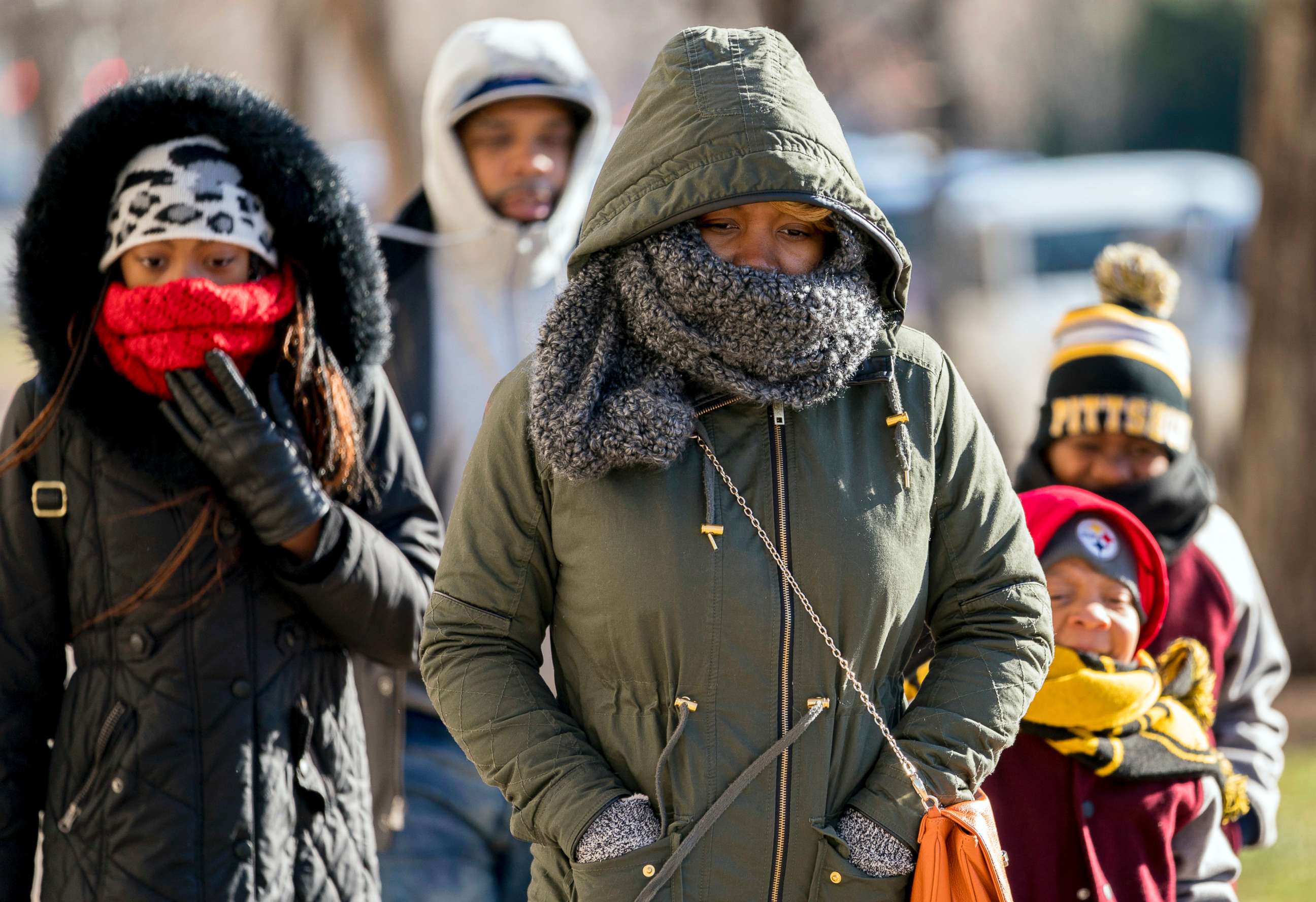 PHOTO: A family braves temperatures in the teens as they make their way to the National Museum of African American History and Culture on the National Mall, Dec. 28, 2017, in Washington.