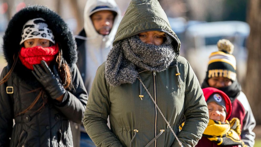 PHOTO: A family braves temperatures in the teens as they make their way to the National Museum of African American History and Culture on the National Mall, Dec. 28, 2017, in Washington.