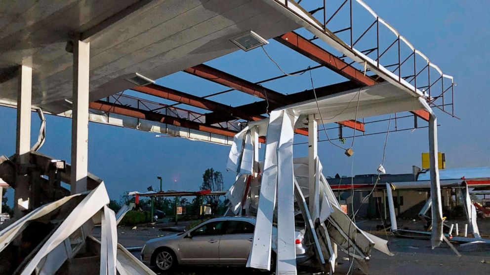 PHOTO: A car is trapped under the fallen metal roof of the Break Time gas station and convenience store in tornado-hit Jefferson City, Mo., May 23, 2019.