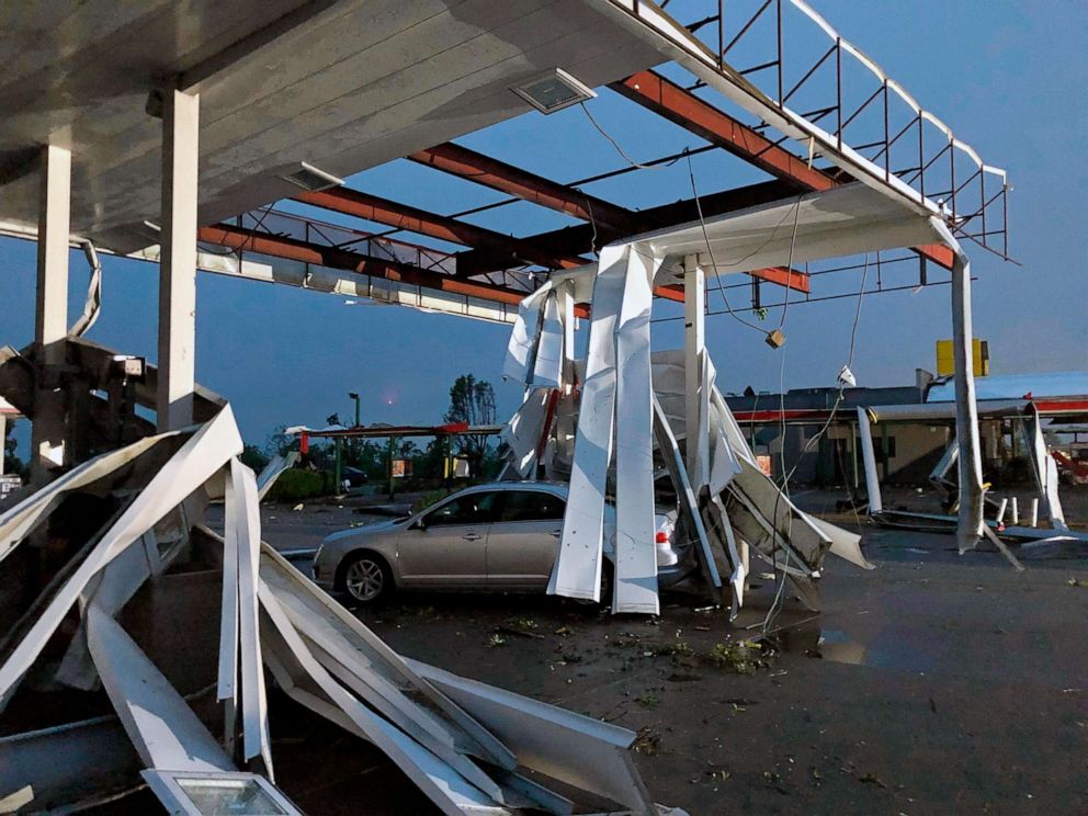 PHOTO: A car is trapped under the fallen metal roof of the Break Time gas station and convenience store in tornado-hit Jefferson City, Mo., May 23, 2019.