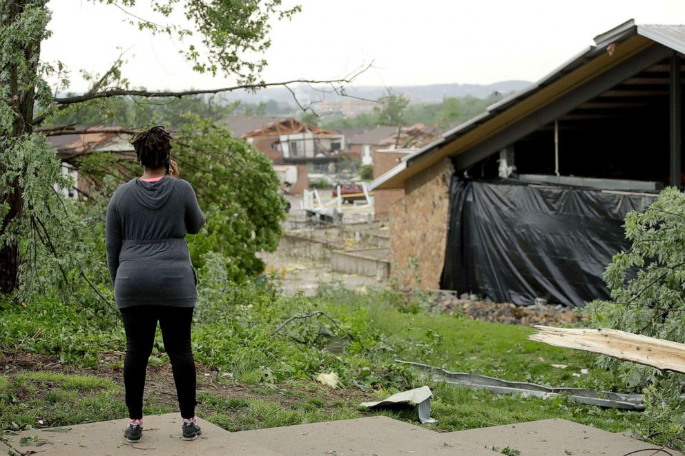 PHOTO:A woman surveys damage, May 23, 2019, after a tornado tore though Jefferson City, Mo. May 22, 2019.