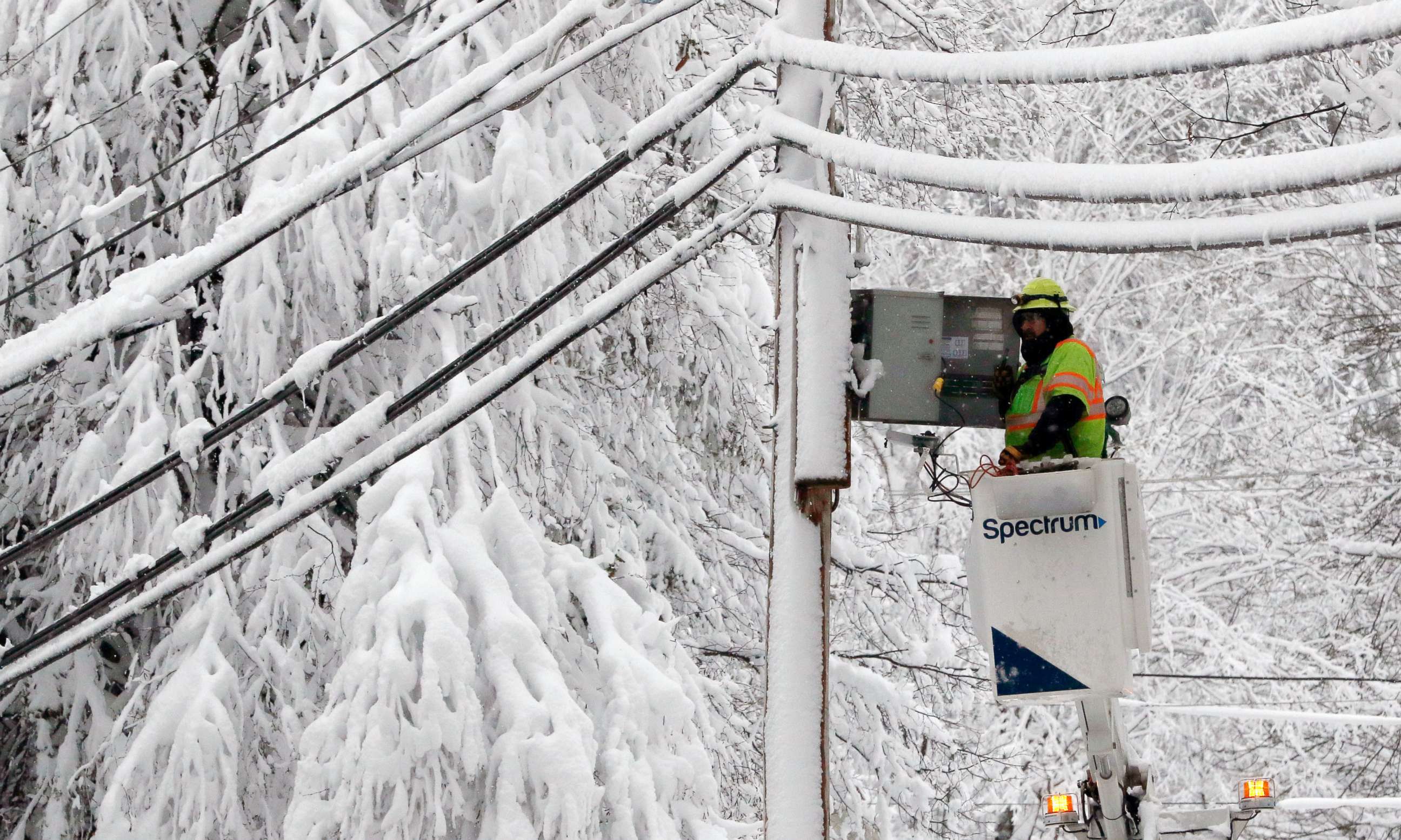 PHOTO: A lineman works to restore power amid limbs sagging with heavy wet snow after a snowstorm, March 8, 2018, in Northborough, Mass.  
