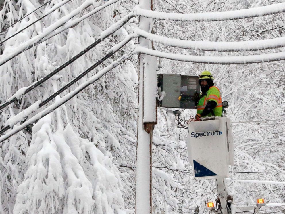 PHOTO: A lineman works to restore power amid limbs sagging with heavy wet snow after a snowstorm, March 8, 2018, in Northborough, Mass.
