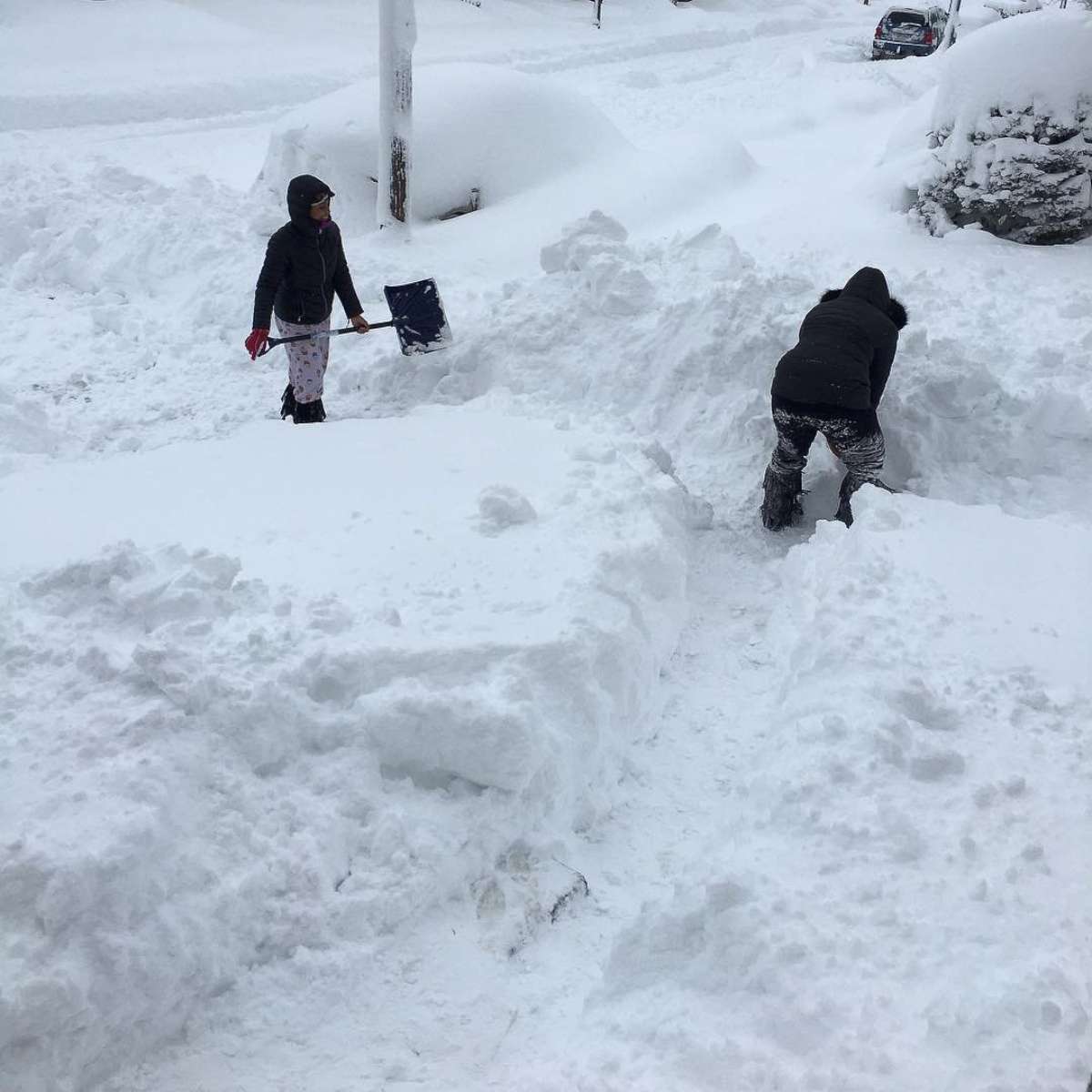 PHOTO: People dig out the path by their house after the record snowfall in Erie, Penn., Dec. 26, 2017, in this picture obtained from social media. 