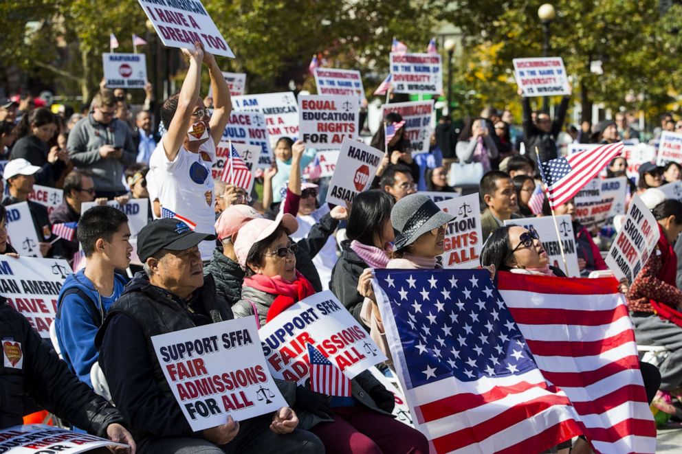 PHOTO: Demonstrators against Harvard University's admission process hold signs and American flags while gathering during a protest at Copley Square in Boston, Oct. 14, 2018.