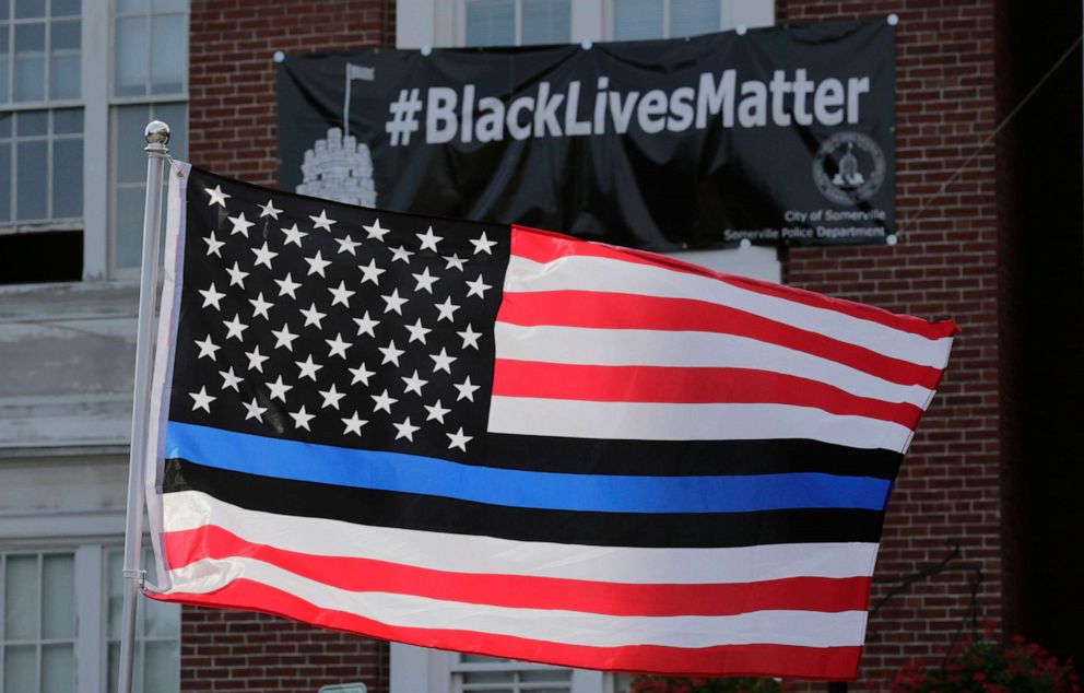 PHOTO: A flag with a blue and black stripes in support of law enforcement officers, flies at a protest by police and their supporters outside Somerville City Hall in Somerville, Mass., July 28, 2016.