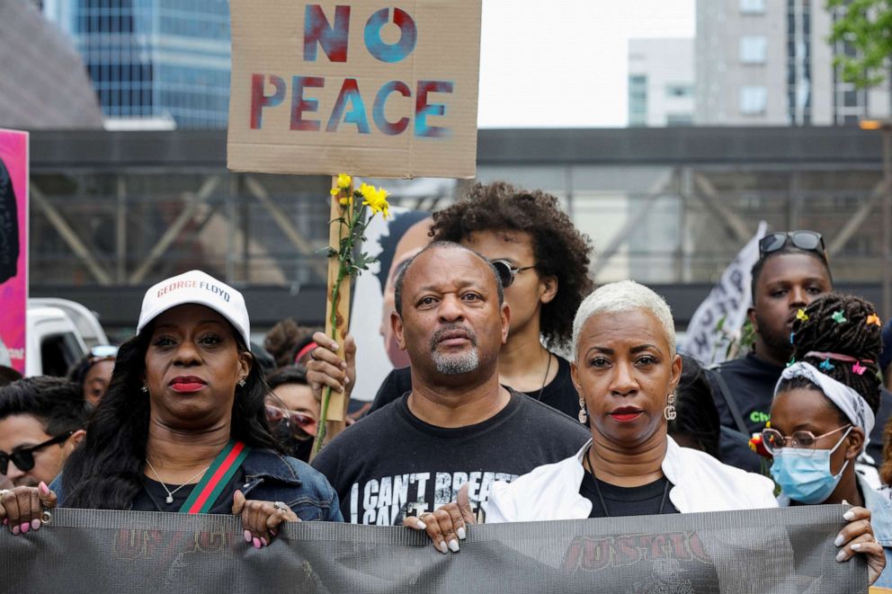 PHOTO: George Floyd's cousin Shareeduh Tate, front right, holds a banner while marching with others during the "One Year, What's Changed?" rally to commemorate the first anniversary of his death, in Minneapolis, May 23, 2021.