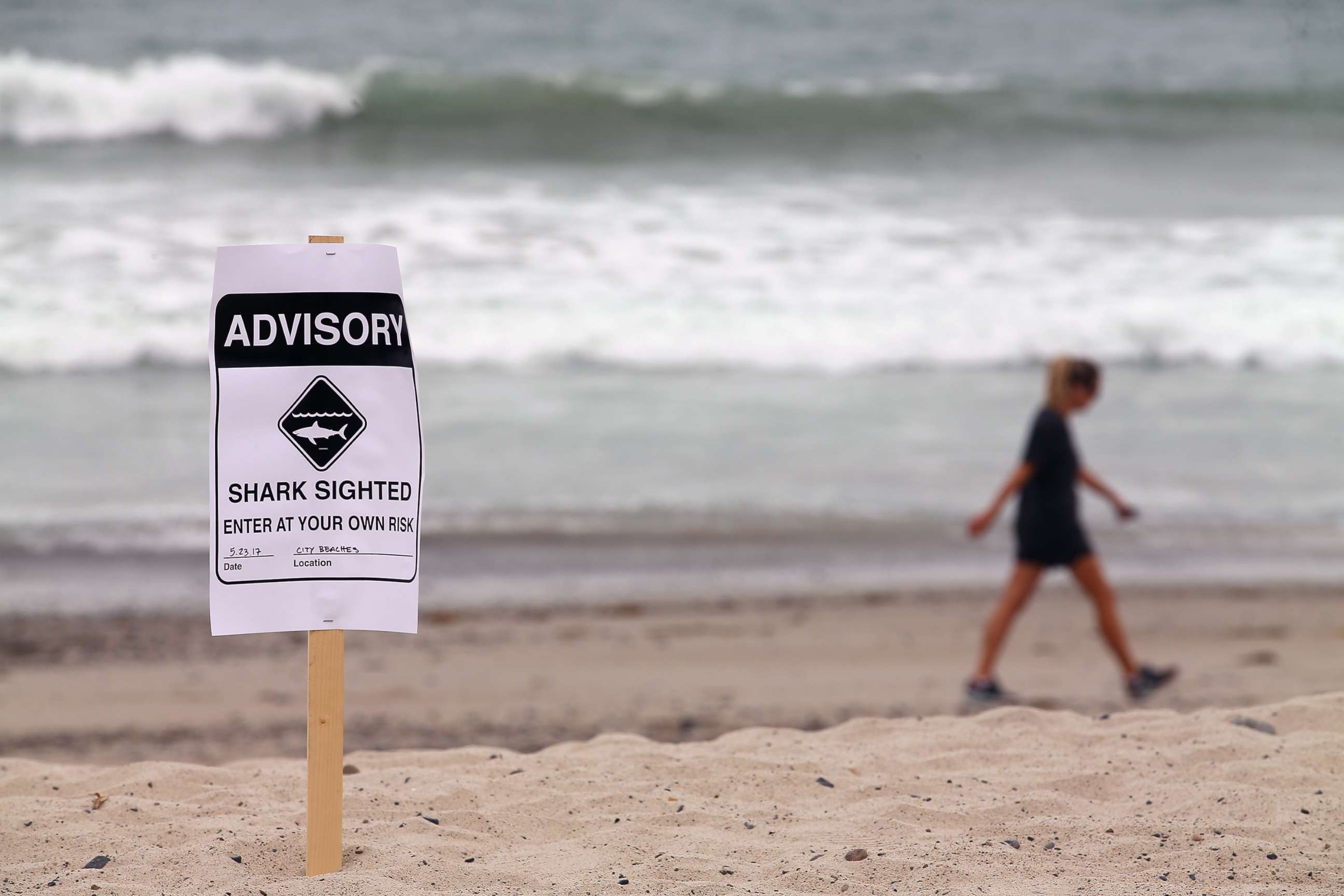 PHOTO: Warning signs are placed along the beach to warn swimmers and surfers of recent shark sightings in San Clemente, Calif., May 23, 2017.