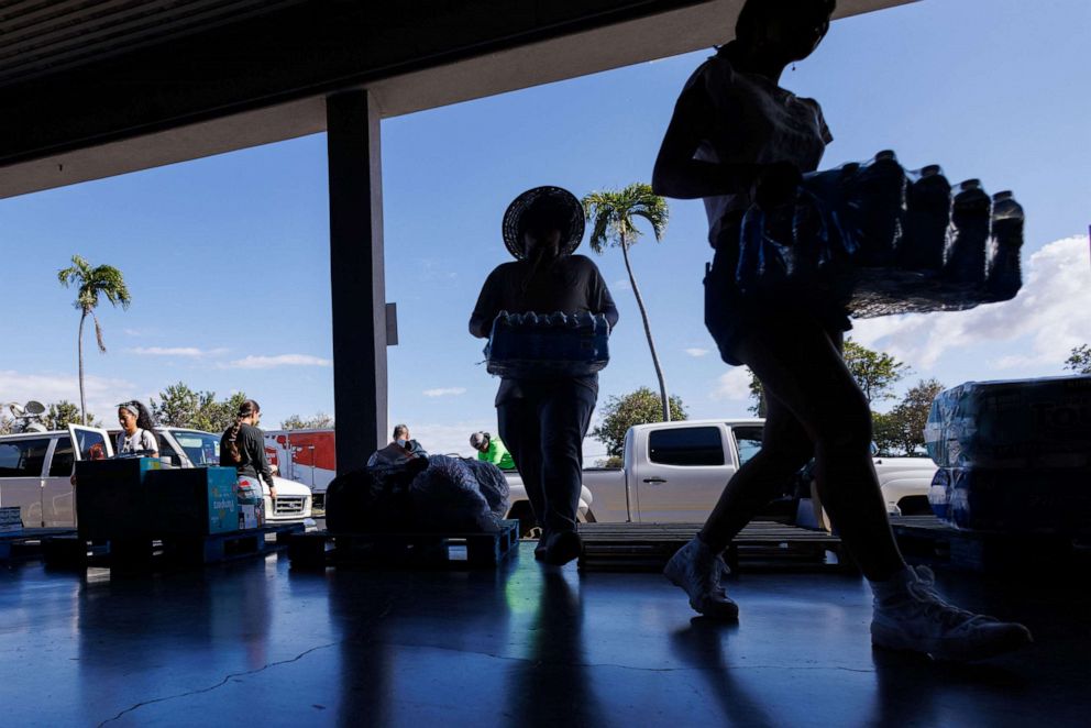 PHOTO: Volunteers help with community donations of drinking water at King's Cathedral church as residents come together to help people effected by the wildfires on Maui island, in Hawaii, U.S., August 11, 2023.