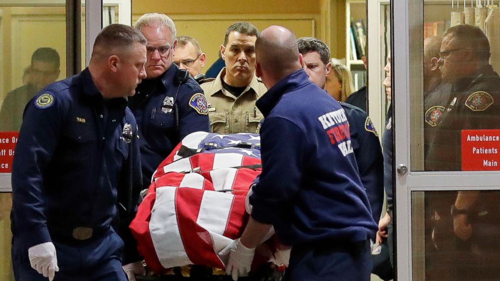 PHOTO: The body of a Kittitas County Sheriff's deputy is draped with a U.S. flag as it is carried out of Kittitas Valley Healthcare Hospital, March 20, 2019, in Ellensburg, Wash.