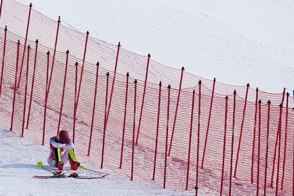 PHOTO: Mikaela Shiffrin, of the United States sits on the side of the course after skiing out in the first run of the women's slalom at the 2022 Winter Olympics, Wednesday, Feb. 9, 2022, in the Yanqing district of Beijing.