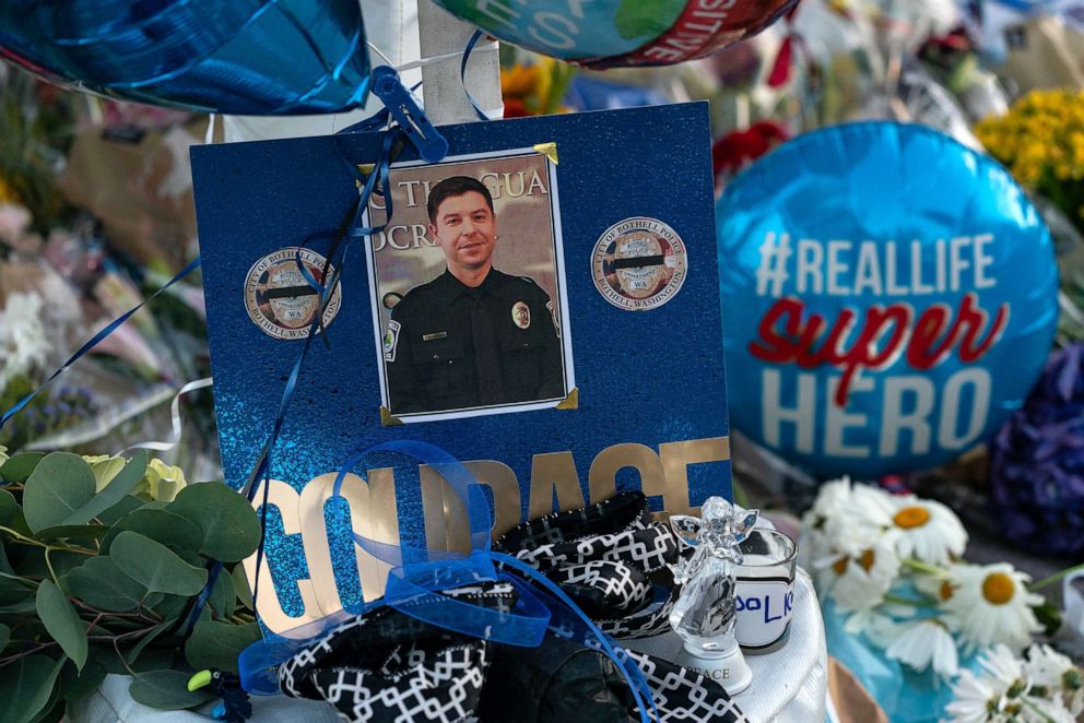 PHOTO: A photo of slain Police Officer Jonathan Shoop is displayed at a memorial outside the Bothell Police Department on July 14, 2020 in Bothell, Wa. Shoop was shot and killed after a pursuit following a traffic stop on July 13, 2020.
