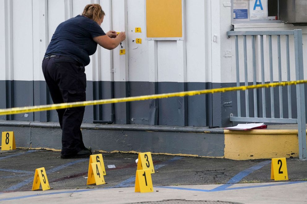 PHOTO: LAPD crime investigators collect evidence at one of the scenes of a shooting, a Shell gas station in the North Hollywood section of Los Angeles on Thursday, July 25, 2019.