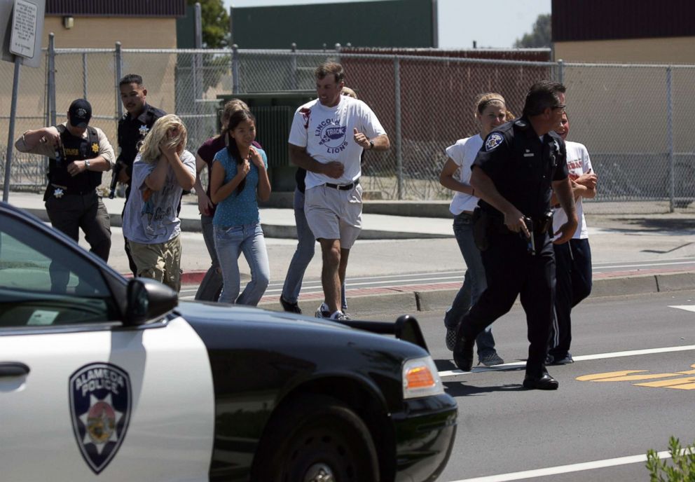 PHOTO: An Alameda Police officer evacuates volunteer students wearing makeup to simulate injuries during a school shooting and mass evacuation drill at Lincoln Middle School, May 22, 2007, in Alameda, Calif.