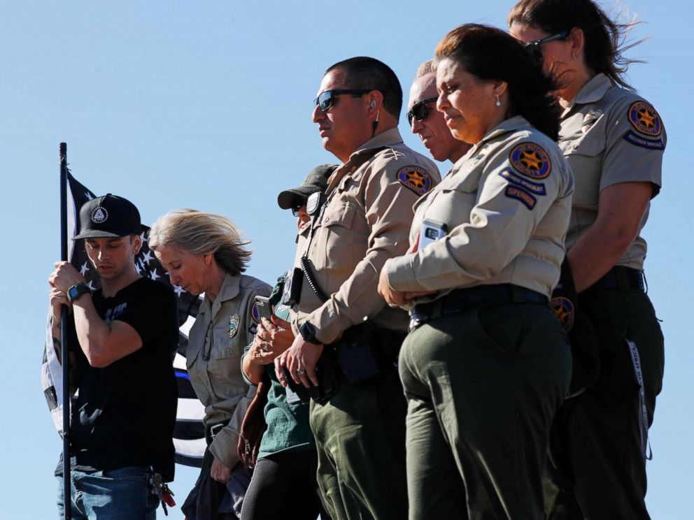 PHOTO: Ventura County Sheriff officers await a procession for the body of Sergeant Ron Helus, who died in a shooting incident at a Thousand Oaks bar, in Thousand Oaks, Calif., Nov. 8, 2018.