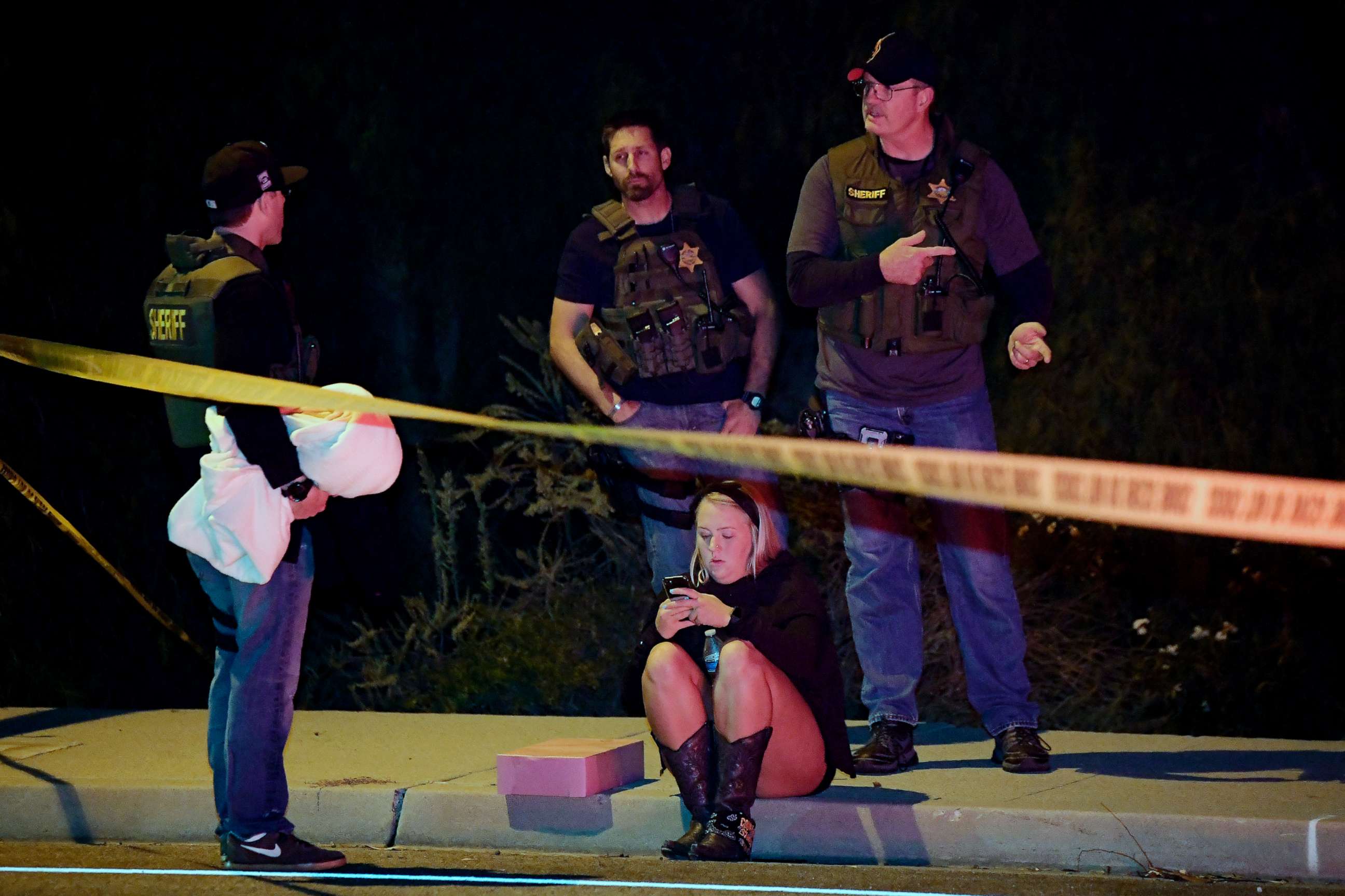 PHOTO: Sheriff's deputies speak to a potential witness as they stand near the scene where a gunman opened fire, Nov. 8, 2018, in Thousand Oaks, Calif.