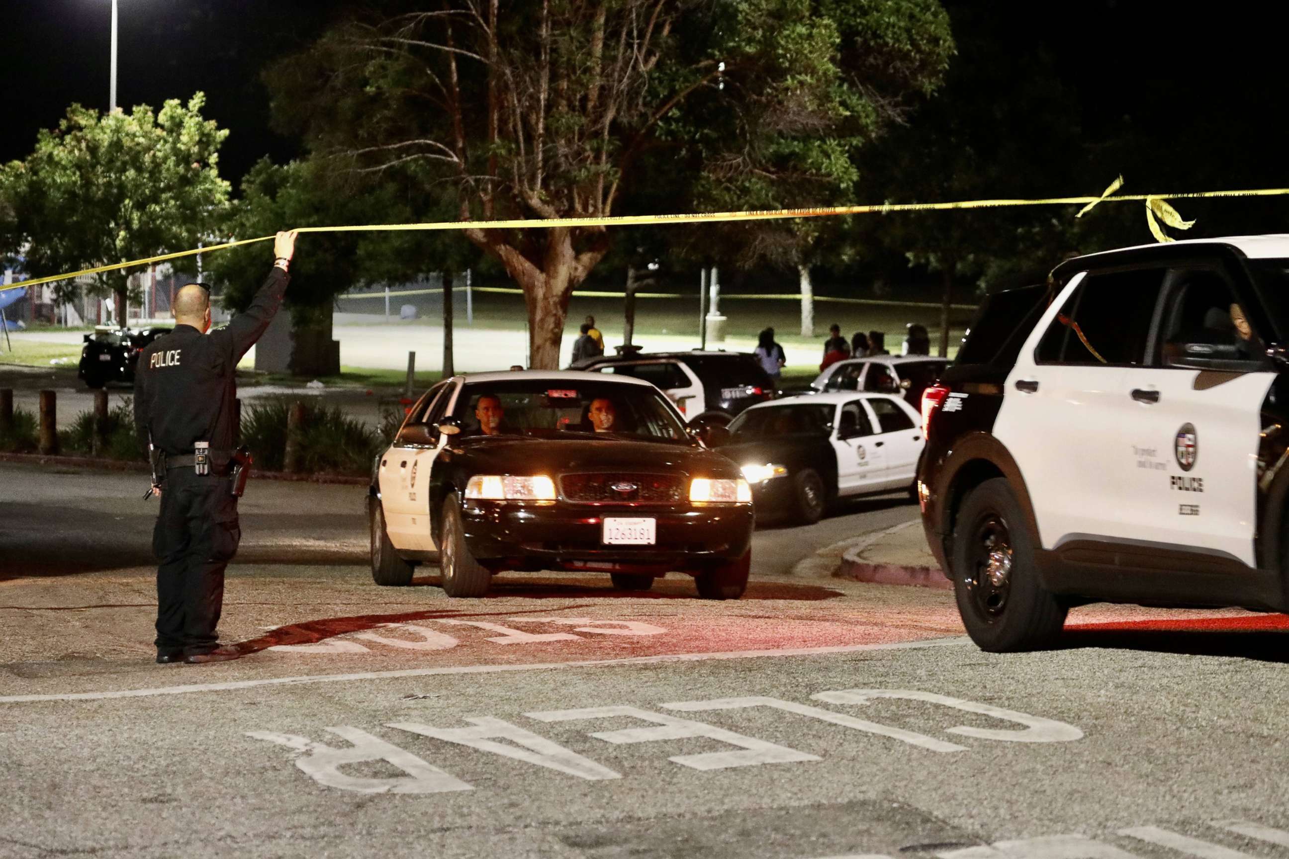 PHOTO: Police officers investigate after a shooting at Peck Park, Los Angeles, July 24, 2022.