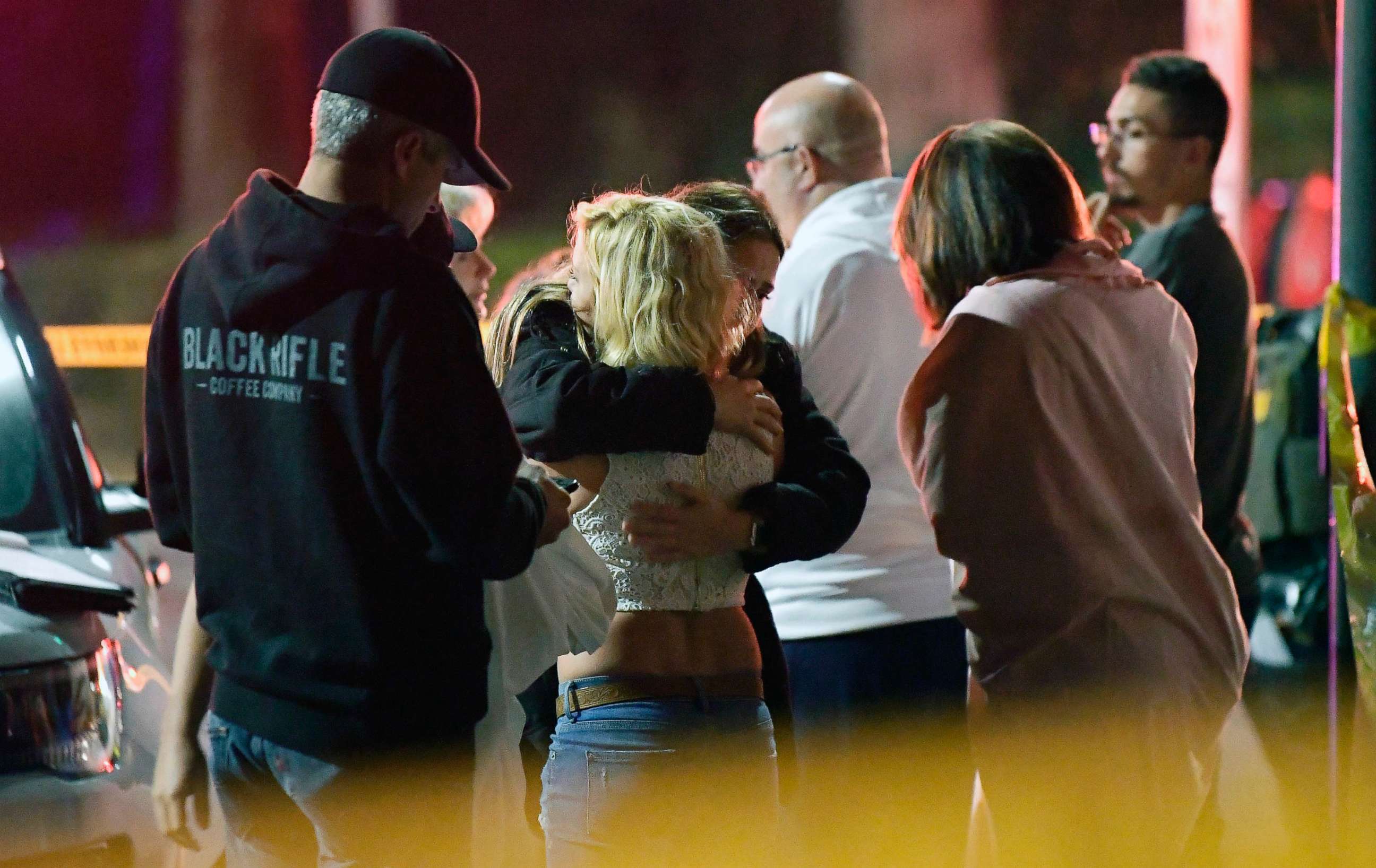 PHOTO: People comfort each other as they stand near the scene, Nov. 8, 2018, in Thousand Oaks, Calif., where a gunman opened fire Wednesday inside a country dance bar crowded with hundreds of people on "college night."