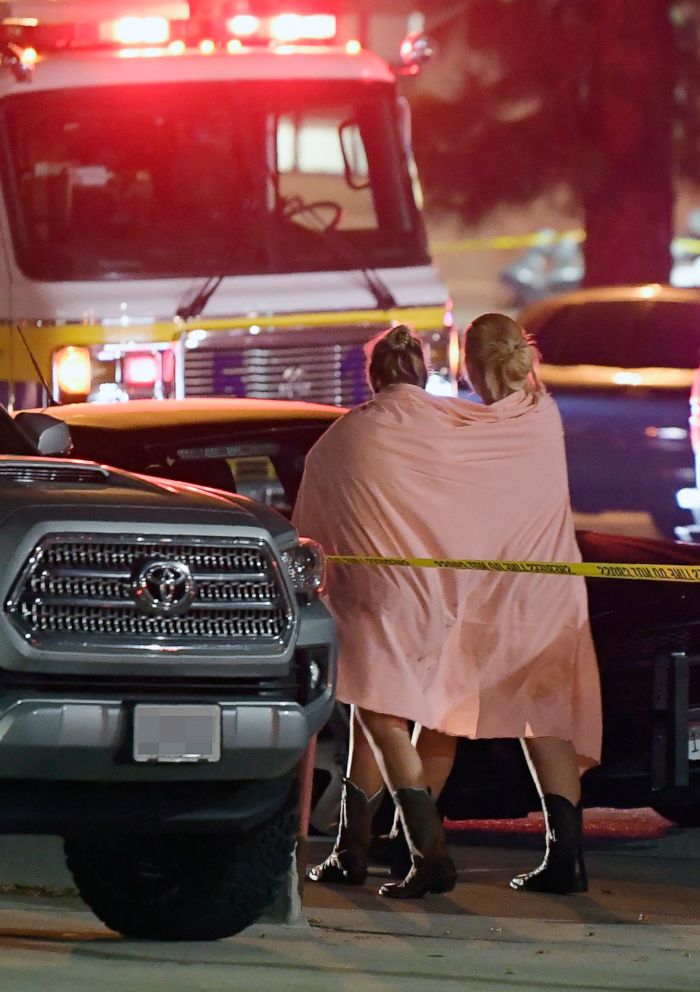 PHOTO: People walk away from the scene, Nov. 8, 2018, in Thousand Oaks, Calif., where a gunman opened fire Wednesday inside a country dance bar crowded with hundreds of people on college night.