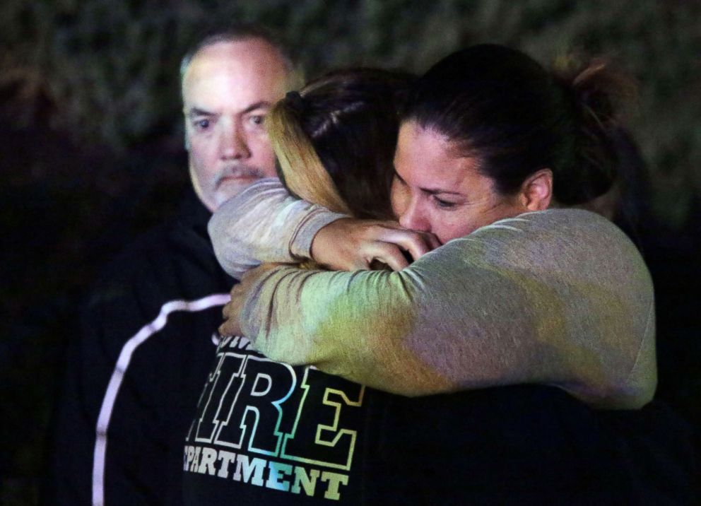 PHOTO: A woman who fled the Borderline Bar and Grill is hugged by relatives in Thousand Oaks, Calif. Nov. 8,  2018.