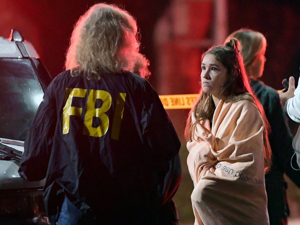 PHOTO: An FBI agent talks to a potential witness as they stand near the scene, Nov. 8, 2018, in Thousand Oaks, Calif. where a gunman opened fire Wednesday inside a country dance bar crowded with hundreds of people on college night.