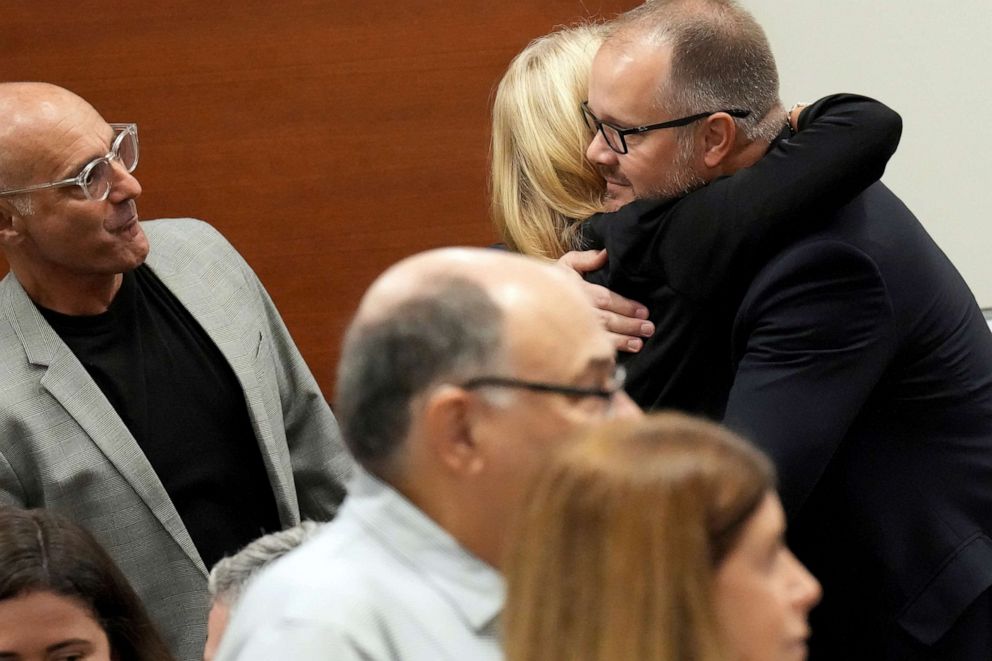 PHOTO: Ryan Petty hugs Annika Dworet, shown with her husband, Mitch Dworet at the Broward County Courthouse in Fort Lauderdale, Oct. 11, 2022.