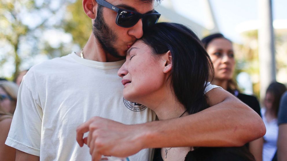PHOTO: Students Nicole Baltzer, right, and Alex Debs, embrace, Feb. 15, 2018, in Parkland, Fla., during a community vigil for the victims of the shooting at Marjory Stoneman Douglas High School. 