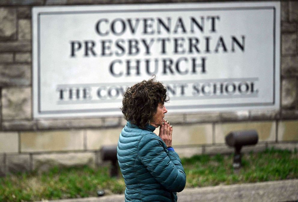PHOTO: Robin Wolfende prays at a makeshift memorial for victims outside the Covenant School building at the Covenant Presbyterian Church following a shooting, in Nashville, March 28, 2023.