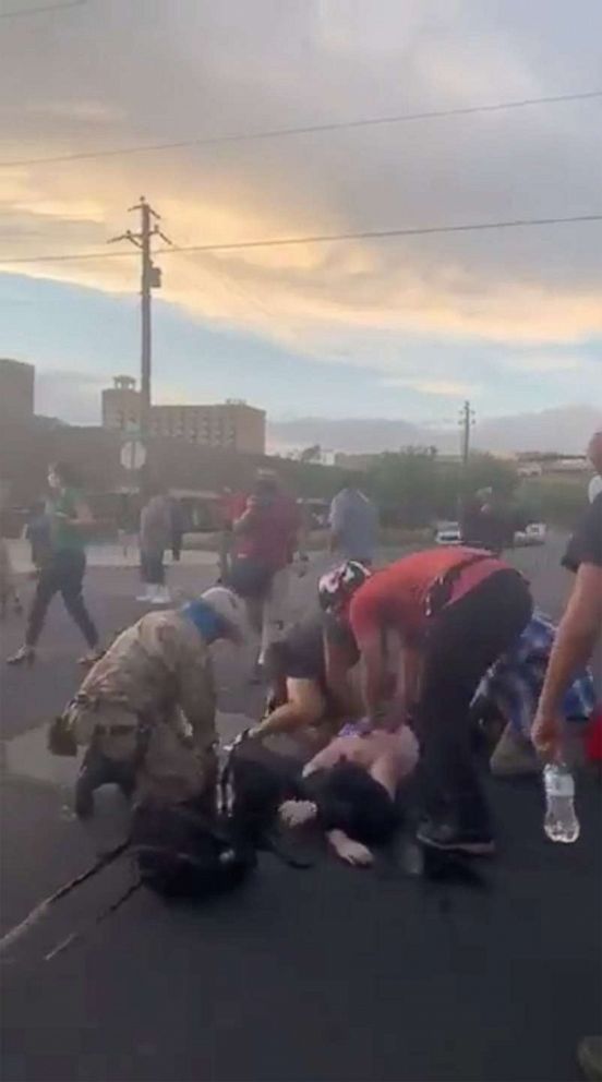 PHOTO: People help a man who was shot and wounded during clashes between a group of armed men and protesters trying to pull down a statue of Spanish conquistador Juan de Onate in Albuquerque, New Mexico, on June 15, 2020.