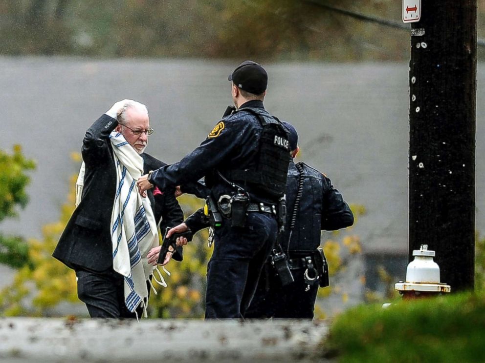 PHOTO: A man is escorted out of the Tree of Life congregation by police following a shootout at the Pittsburg synagogue on October 27, 2018.